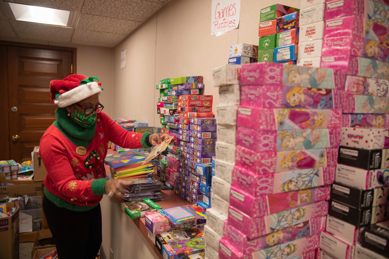 Nita Ford-Hightower, Child Youth Education Services, arranges toys and games donated from members of the community for the School Liaison Toy Drive Dec. 17, 2020, at Joint Base San Antonio-Fort Sam Houston, Texas