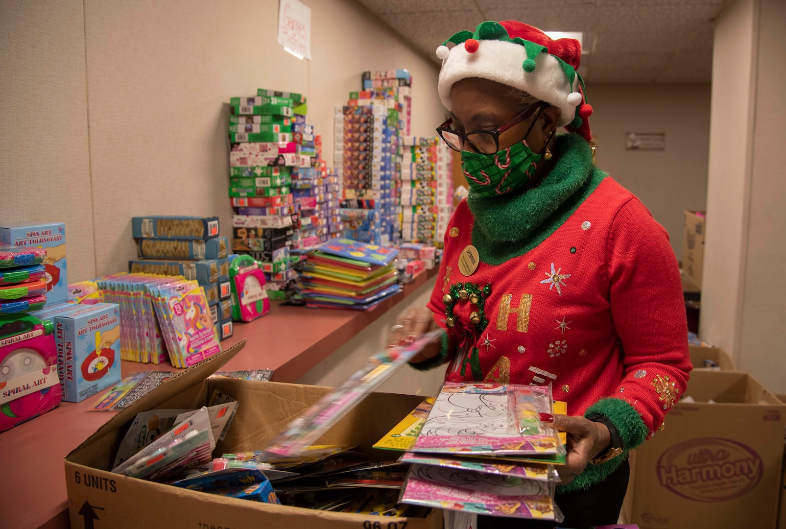 Nita Ford-Hightower, Child Youth Education Services, arranges toys and games donated from members of the community for the School Liaison Toy Drive Dec. 17, 2020, at Joint Base San Antonio-Fort Sam Houston, Texas.
