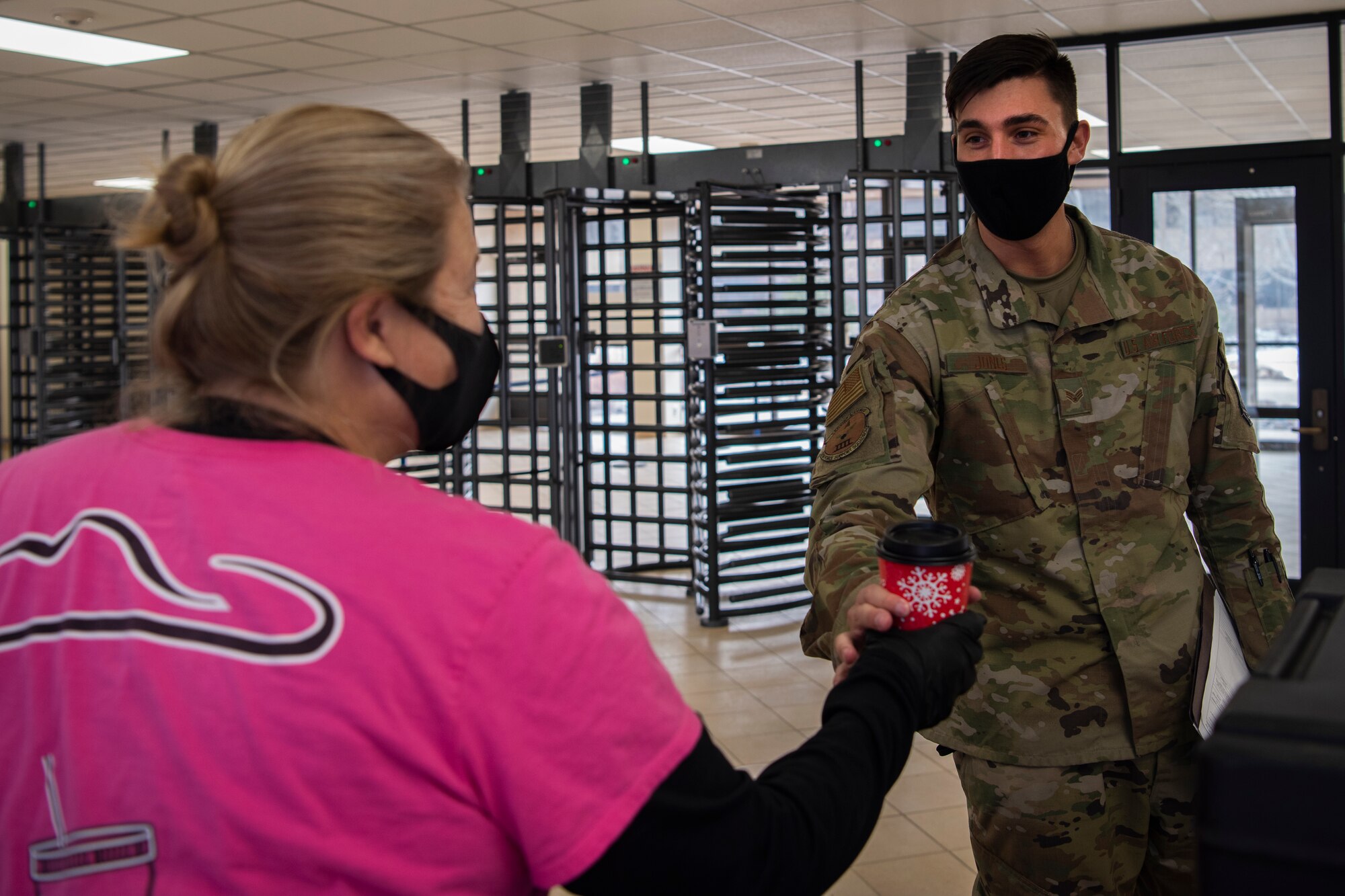 Senior Airman Zachary Jones, 50th Operations Support Squadron commanders support staff, receives a free hot chocolate courtesy of the 50th Force Support Squadron Dec. 18, 2020, at Schriever Air Force Base, Colorado. The event, hosted by the 50th FSS, was made possible with the support of ENT Bank and Cowgirl Kettle Popcorn. (U.S. Space Force photo by Airman 1st Class Jonathan Whitely)