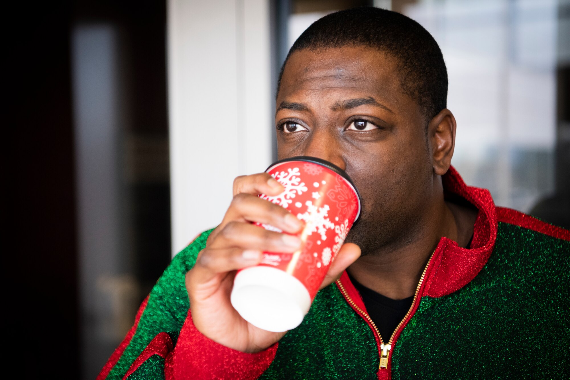 Staff Sgt. Lloyd Morris, 21st Comptroller Squadron, noncommissioned officer in charge of financial operations, drinks a free hot chocolate, courtesy of the 50th Force Support Squadron Dec. 18, 2020, at Schriever Air Force Base, Colorado. Airmen received the hot chocolate as a “thank you” for the hard work they put in every day. (U.S. Space Force photo by Airman 1st Class Jonathan Whitely)
