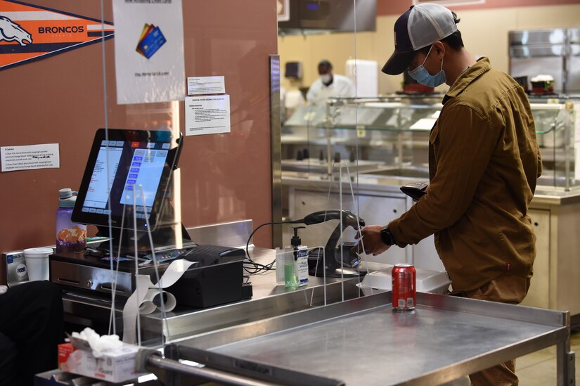 A contractor uses his phone to pay for his meal at the Guardian Dining Facility on Creech Air Force Base.