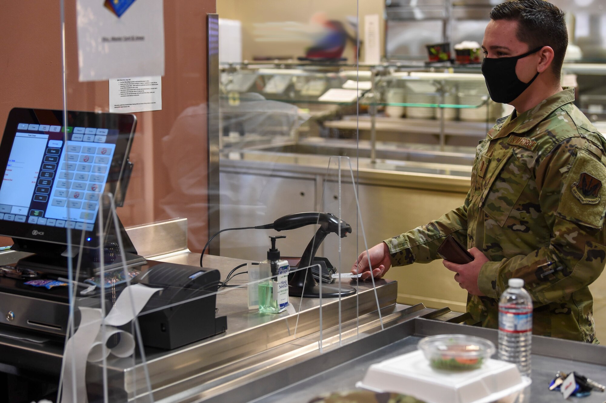 2nd Lt. Tyler, 432nd Operations Support Squadron pilot, uses his debit card in the Guardian Dining Facility at Creech Air Force Base.