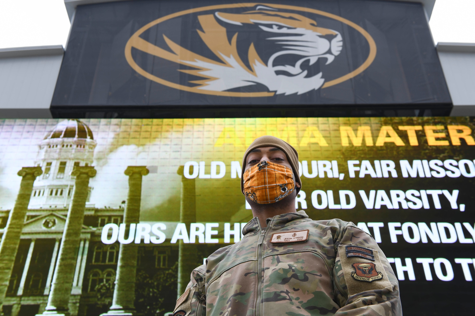 U.S. Air Force Tech. Sgt. Justin Stinson, 393rd Bomb Squadron superintendent, stands in front of a JumboTron at the University of Missouri, Columbia, Missouri, Dec. 12, 2020. Team Whiteman personnel attended the game to participate in the 22nd Annual Adopt A Warrior military recognition. The Exercise Tiger Association host the annual event to show honor and appreciation for service members’ sacrifice and to recognize the militaries outstanding achievements and meritorious service to U.S. and its allies. (U.S. Air Force photo by Staff Sgt. Sadie Colbert)