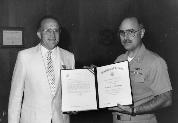 Shipyard Commander, Rear Adm. Lewis A. Felton presents Gilbert Stevens the Navy Meritorious Civilian Service Award for his contribution in developing the buoyancy tank system at PNS, July 20, 1992.