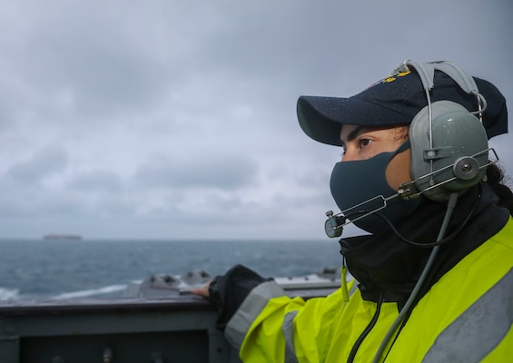 EAST CHINA SEA (Dec. 18, 2020) Retail Specialist Third Class Isis A. Hernandez, from Albuquerque, New Mexico, stands lookout watch on the bridge wing as the guided-missile destroyer USS Mustin (DDG 89) conducts routine underway operations. Mustin is forward-deployed to the U.S. 7th Fleet area of operations. All nations benefit from free and open access to the maritime domain. We will foster a united, global effort to safeguard this access. (U.S. Navy photo by Mass Communication Specialist Third Class Arthur Rosen)