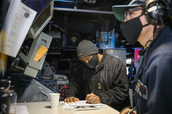 EAST CHINA SEA (Dec. 18, 2020) Operations Specialist Chief Dayshawn Davis, from Catawba, North Carolina, and Operations Specialist Seaman Apprentice William Viveros, from Fort Worth, Texas, maintain logs in the combat room as the guided-missile destroyer USS Mustin (DDG 89) conducts routine underway operations. Mustin is forward-deployed to the U.S. 7th Fleet area of operations. All nations benefit from free and open access to the maritime domain. We will foster a united, global effort to safeguard this access. (U.S. Navy photo by Mass Communication Specialist Third Class Arthur Rosen)