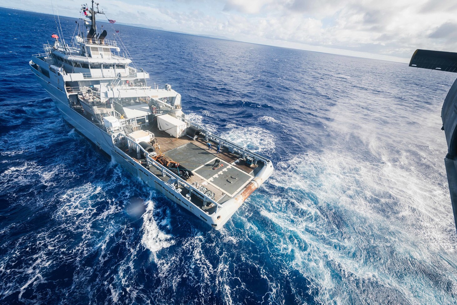 PHILIPPINE SEA (Dec. 10, 2020) Naval Air Crewman (Helicopter) 2nd Class Robert Washington, from Birmingham, Mich., assigned to the “Island Knights” of Helicopter Sea Combat Squadron 25, secures a litter during hoist training with French Loire-class tender, and support vessel FS Seine (A 604) to ensure both nations maintain proficiency in personnel recovery while out at sea. HSC-25, the Navy’s only forward-deployed expeditionary helicopter sea combat squadron, provides a multi-mission rotary wing capability for units in the U.S. 7th Fleet area of operations and maintains a Guam-based 24-hour search and rescue and medical evacuation capability, directly supporting the U.S. Coast Guard and Joint Region Marianas. (U.S. Navy photo by Mass Communication Specialist 2nd Class Cole C. Pielop)