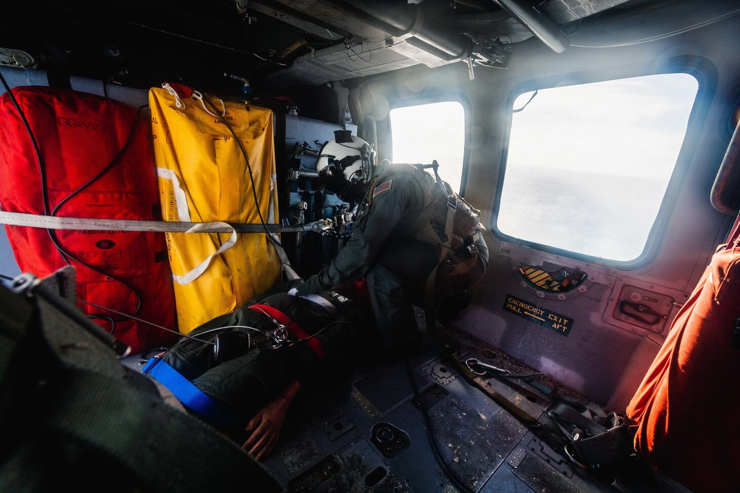 PHILIPPINE SEA (Dec. 10, 2020) Naval Air Crewman (Helicopter) 3rd Class Justin Jones, from Round Rock, Tex., assigned to the “Island Knights'' of Helicopter Sea Combat Squadron 25, secures a litter in an MH-60S Sea Hawk helicopter during hoist training with French Loire-class tender, and support vessel FS Seine (A 604) to ensure both nations maintain proficiency in personnel recovery while out at sea. HSC-25, the Navy’s only forward-deployed expeditionary helicopter sea combat squadron, provides a multi-mission rotary wing capability for units in the U.S. 7th Fleet area of operations and maintains a Guam-based 24-hour search and rescue and medical evacuation capability, directly supporting the U.S. Coast Guard and Joint Region Marianas. (U.S. Navy photo by Mass Communication Specialist 2nd Class Cole C. Pielop)