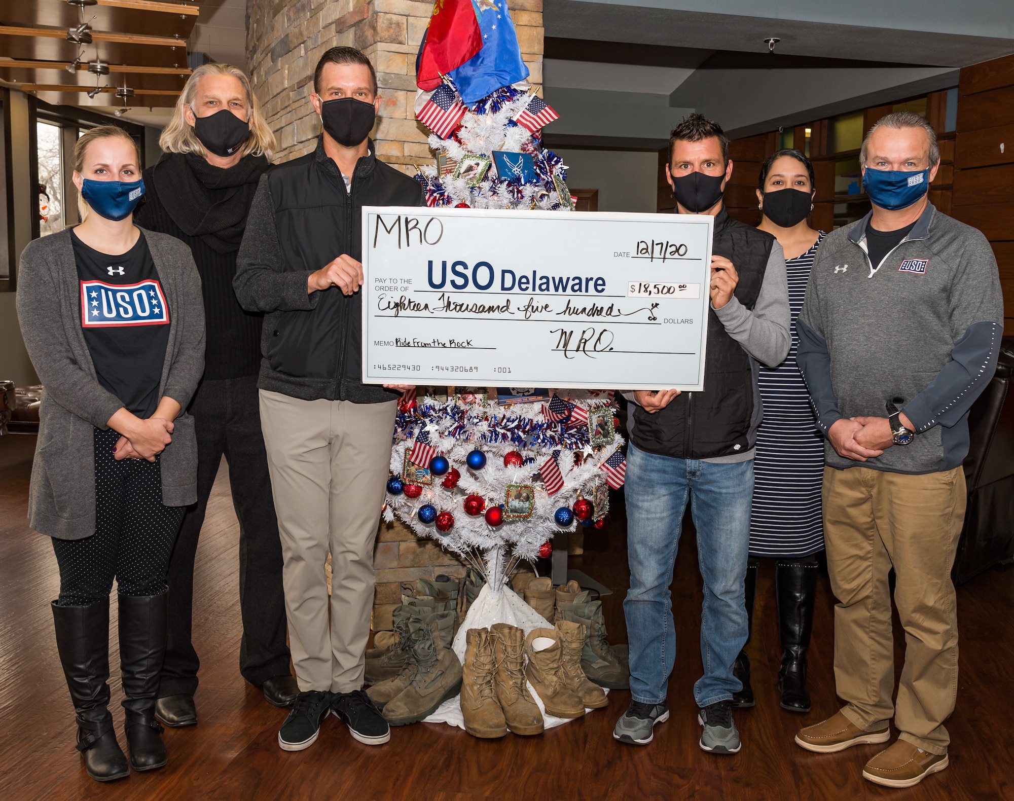 Cari Matthews, USO Delaware center operations supervisor; Billy Mauldin, Motor Racing Outreach president and senior chaplain; Nick Terry, MRO chaplain; Jamie Turski, Stewart Haas Racing tire specialist; Yolanda Bortoff, USO Delaware center operations and program manager; and Bruce Kmiec, USO Delaware executive director, hold a check in the amount of $18,500 made out to USO Delaware Dec. 7, 2020, at the USO lounge on Dover Air Force Base, Delaware. Terry and Turski donated the check, which they received from pledges and donations from a bike ride they participated in on Sept. 29. The bike ride started at Rockingham Speedway, Rockingham, North Carolina, and ended at Wrightsville Beach. (U.S. Air Force photo by Roland Balik