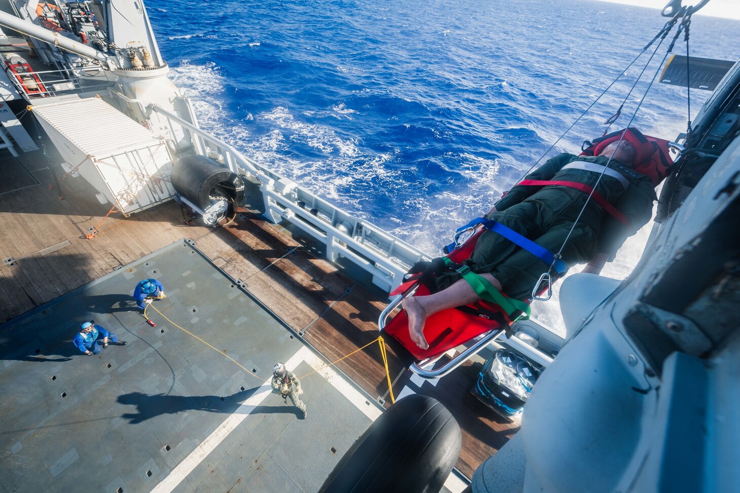 PHILIPPINE SEA (Dec. 10, 2020) Naval Air Crewman (Helicopter) 2nd Class Robert Washington, from Birmingham, Mich., assigned to the “Island Knights” of Helicopter Sea Combat Squadron 25, hoists a litter from an MH-60S Sea Hawk helicopter during training with French Loire-class tender, and support vessel FS Seine (A 604) to ensure both nations maintain proficiency in personnel recovery while out at sea. HSC-25, the Navy’s only forward-deployed expeditionary helicopter sea combat squadron, provides a multi-mission rotary wing capability for units in the U.S. 7th Fleet area of operations and maintains a Guam-based 24-hour search and rescue and medical evacuation capability, directly supporting the U.S. Coast Guard and Joint Region Marianas. (U.S. Navy photo by Mass Communication Specialist 2nd Class Cole C. Pielop)