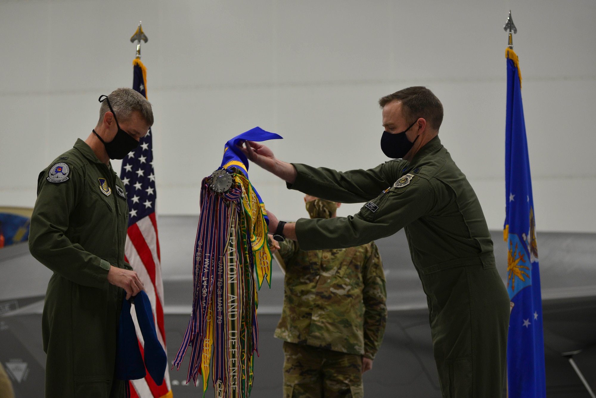 U.S. Air Force Lt. Col. Samuel Chipman unveils the 355th Fighter Squadron guidon during a reactivation ceremony at Eielson Air Force Base, Alaska, Dec. 18, 2020.