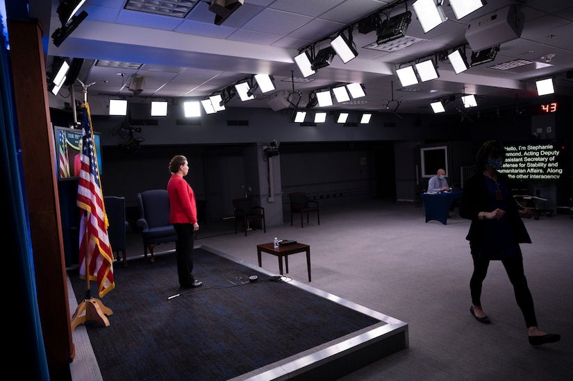 A woman reads from a teleprompter.