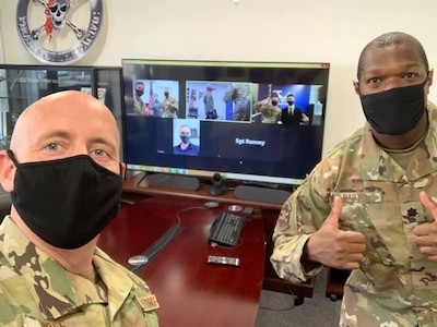 Chief Master Sgt. David Poff, (left) 369th Recruiting Squadron superintendent, and Lt. Col. Charles Barton, 369th RCS commander, celebrate the swearing in of Daniel Kim and Tyler Yarrish into the Air Force Delayed Enlistment Program