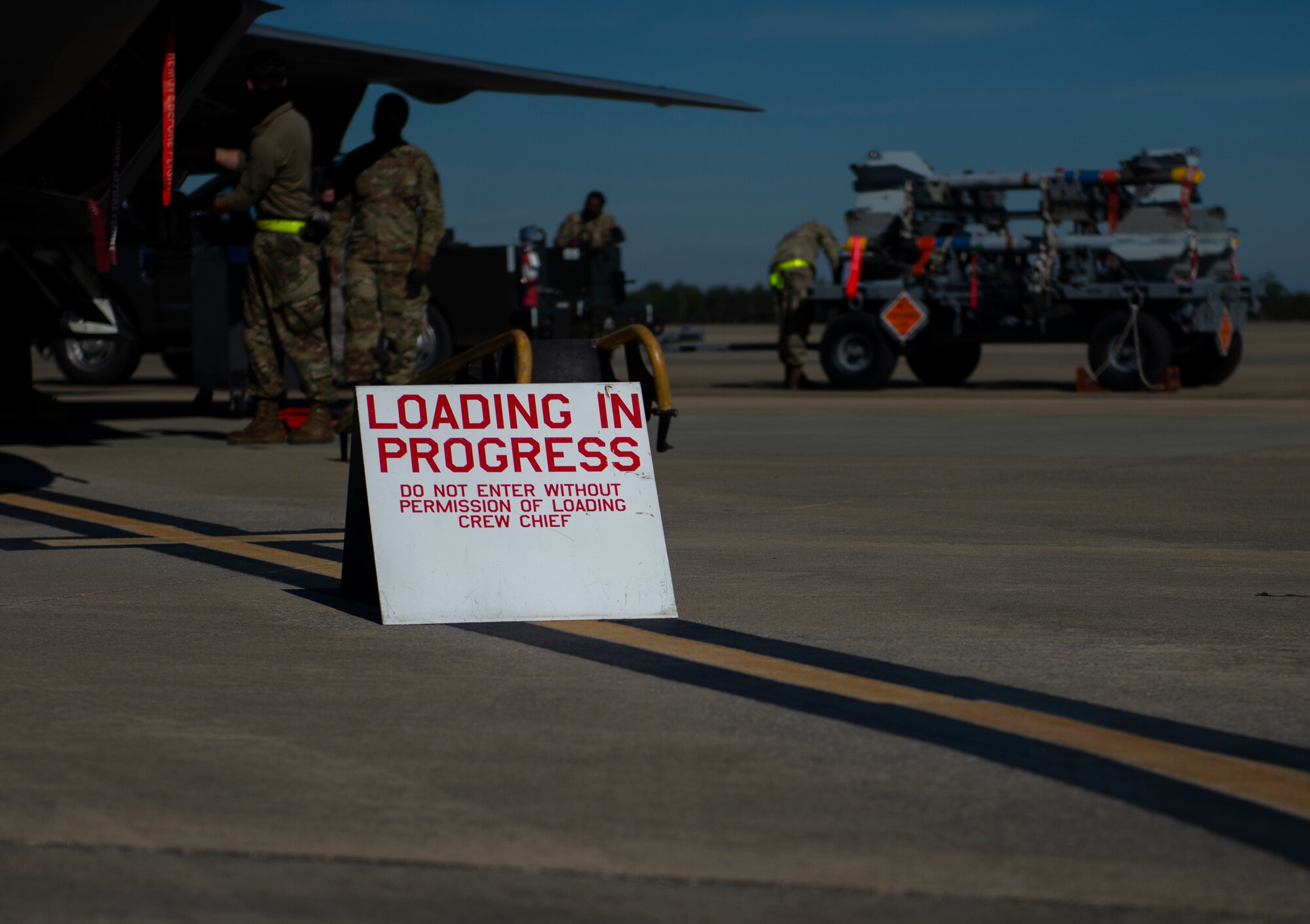 loading in progress sign in foreground men working in background