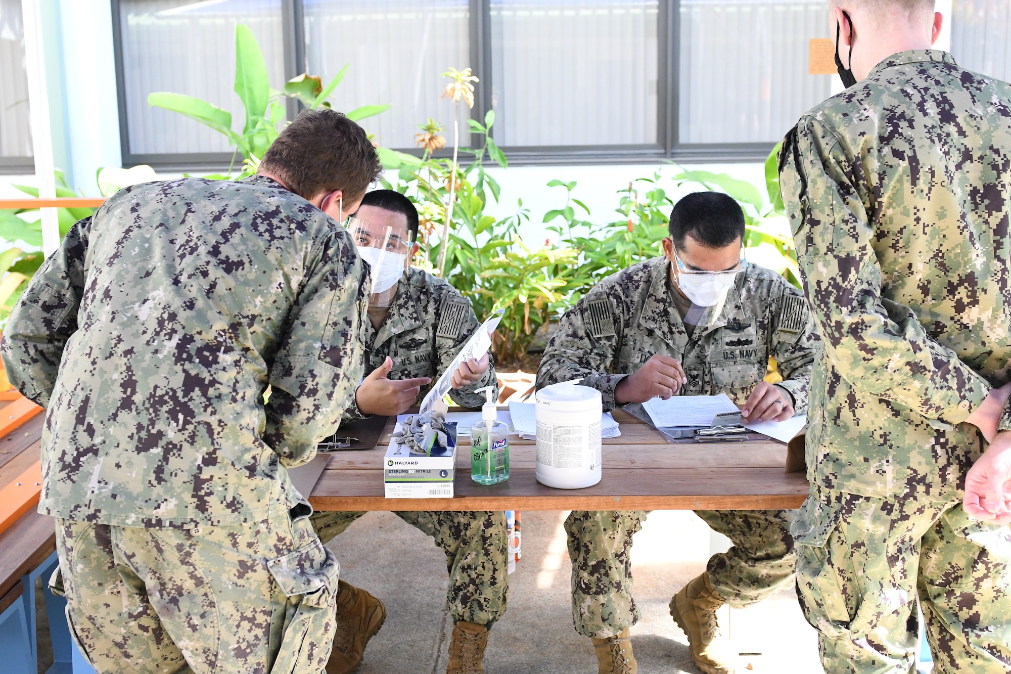 Sailors sign-in to received the COVID-19 vaccine.