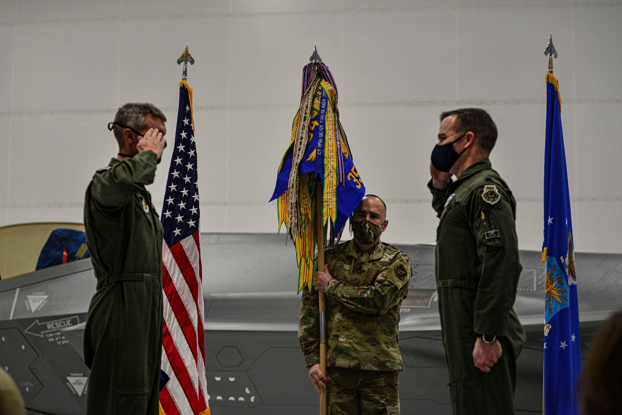 U.S. Air Force Lt. Col. Samuel Chipman renders a salute to Col. David Skalicky, the 354th Operations Group commander, during the 355th Fighter Squadron reactivation ceremony Dec. 18, 2020, at Eielson Air Force Base, Alaska