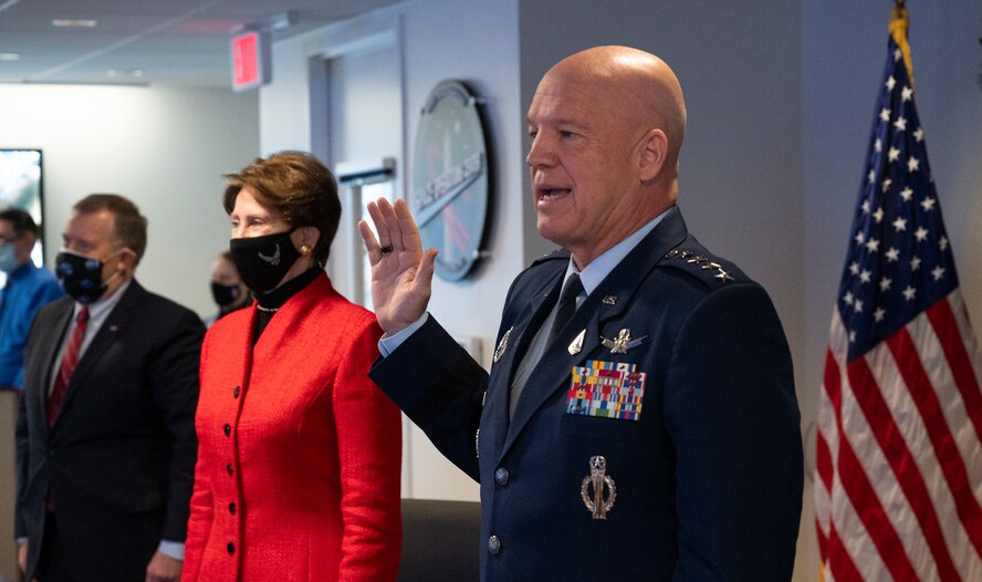 General John Raymond, Chief of Space Operations, U.S. Space Force, center, administers the oath of office to NASA astronaut Mike Hopkins, onboard the International Space Station, as he is transferred from the U.S. Air Force to the U.S. Space Force, Friday, Dec. 18, 2020, from the Space Operations Center at NASA Headquarters in Washington.
