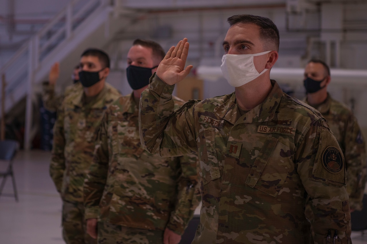 Masked airmen swear oath to the Space Force.