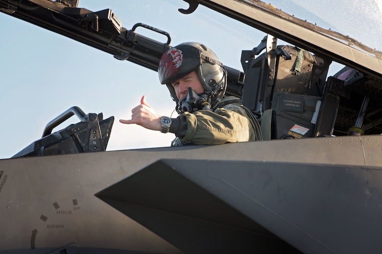 U.S. Air Force Capt. Woodruff Johnson,  494th Fighter Squadron weapons officer and recipient of  the USAF Weapons School Robbie Risner Award, displays a hand signal before flight at Royal Air Force Lakenheath, England, Dec. 17, 2020. The award is presented annually to the outstanding graduate of the USAF Weapons School and commemorates the leadership, courage and patriotism epitomized by Gen. Riser. (U.S. Air Force photo by Senior Airman Shanice Ship)