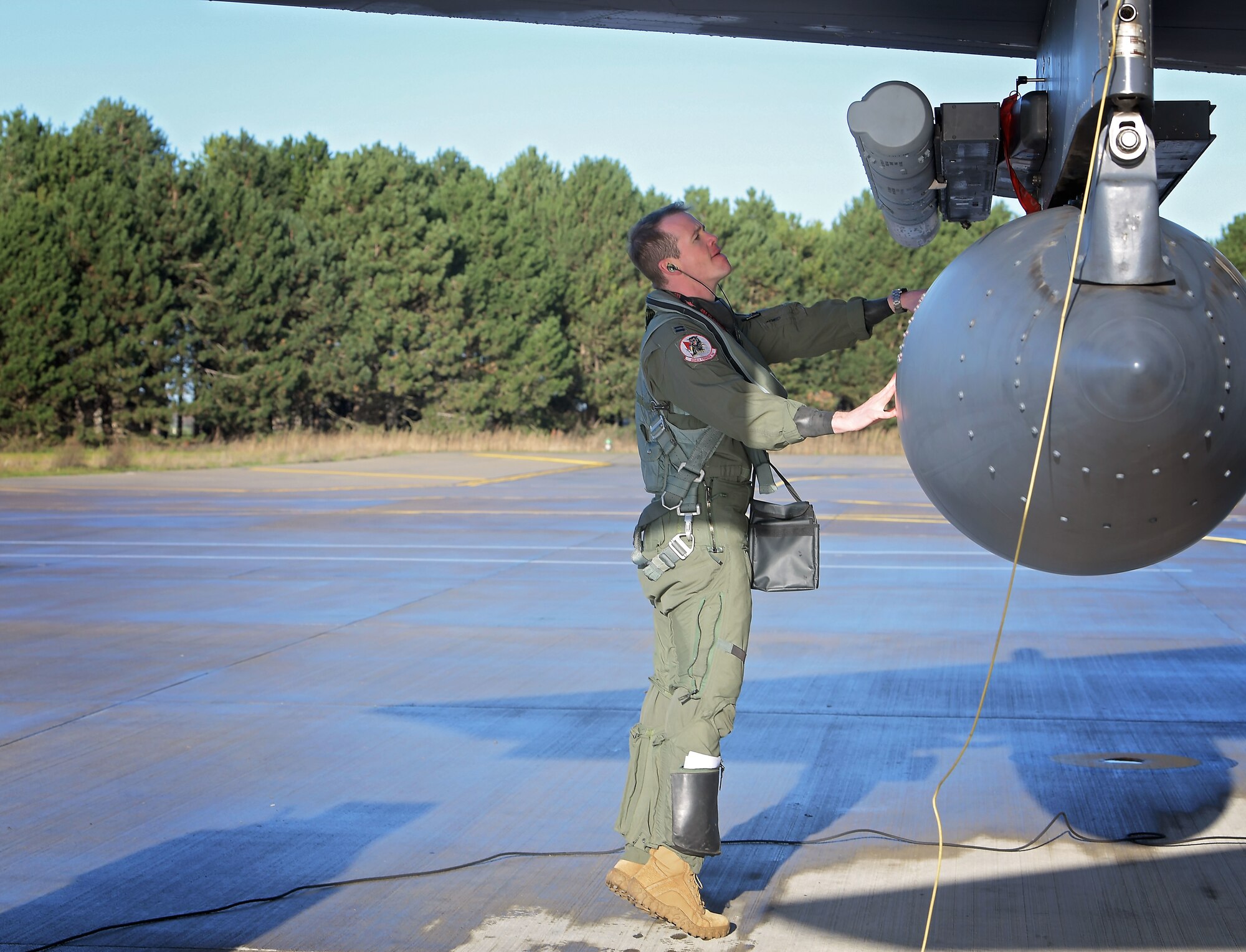 U.S. Air Force Capt. Woodruff Johnson,  494th Fighter Squadron weapons officer, inspects an F-15E Strike Eagle on an aircraft ramp at Royal Air Force Lakenheath, England, Dec. 17, 2020. Johnson is the recipient of the USAF Weapons School Robbie Risner Award this year. (U.S. Air Force photo by Senior Airman Shanice Ship)