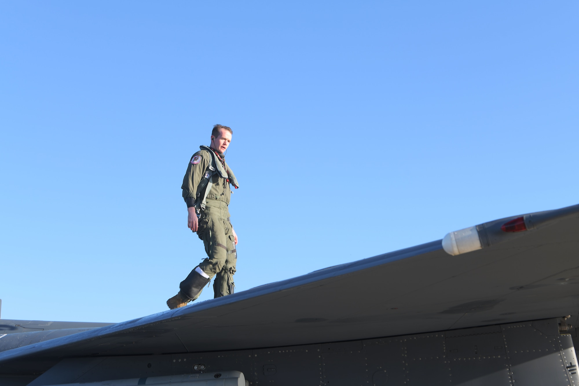 U.S. Air Force Capt. Woodruff Johnson,  494th Fighter Squadron weapons officer, inspects an F-15E Strike Eagle on an aircraft ramp at Royal Air Force Lakenheath, England, Dec. 17, 2020. Johnson is the recipient of the USAF Weapons School Robbie Risner Award this year. (U.S. Air Force photo by Senior Airman Shanice Ship)