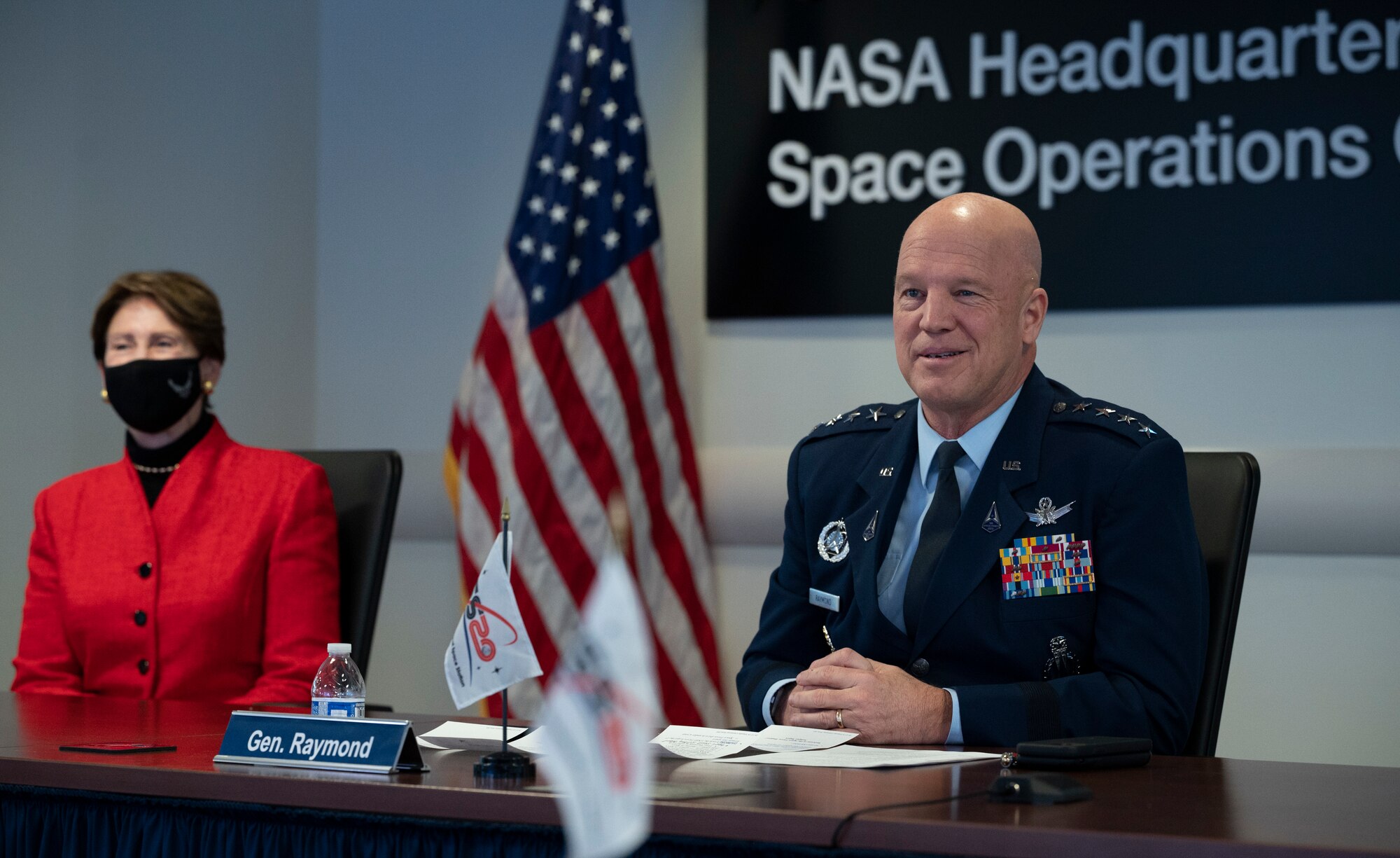 General John Raymond, Chief of Space Operations, U.S. Space Force, right, and Secretary of the Air Force Barbara Barrett left, are seen during a transfer ceremony, Friday, Dec. 18, 2020, from the Space Operations Center at NASA Headquarters in Washington.