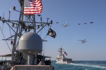 The guided-missile destroyer USS Winston S. Churchill (DDG 81), right, and the Navy patrol coastal ship USS Firebolt (PC 10) transit the Arabian Gulf with Royal Saudi Air Force F-15SA fighter jets, U.S. Air Force F-16 Fighting Falcon fighter jets, a U.S. Navy MH-60R Sea Hawk helicopter and a U.S. Navy P-8A Poseidon aircraft during a joint and combined air operations in support of maritime surface warfare (AOMSW) exercise in the Arabian Gulf, Dec. 18. Combined integration operations between joint U.S. forces are regularly held to maintain interoperability and the capability to counter threats posed in the maritime domain, ensuring freedom of navigation and free flow of commerce throughout the region's heavily trafficked waterways.