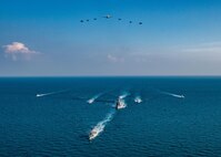 The Royal Saudi Naval Force corvette HMS Badr (612), front to back, the guided-missile destroyer USS Winston S. Churchill (DDG 81), Navy patrol coastal ships USS Squall (PC 7), USS Firebolt (PC 10), Coast Guard patrol boats USCGC Monomoy (WPB 1326), USCGC Maui (WPB 1304) and USCGC Wrangell (WPB 1332) transit the Arabian Gulf with Royal Saudi Air Force F-15SA fighter jets, U.S. Air Force F-16 Fighting Falcon fighter jets, a U.S. Navy MH-60R Sea Hawk helicopter and a U.S. Navy P-8A Poseidon aircraft during the joint and combined air operations in support of maritime surface warfare (AOMSW) exercise in the Arabian Gulf, Dec. 17. Combined integration operations between joint U.S. forces are regularly held to maintain interoperability and the capability to counter threats posed in the maritime domain, ensuring freedom of navigation and free flow of commerce throughout the region's heavily trafficked waterways.