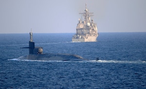 The guided-missile submarine USS Georgia (SSGN 729), front, transits the Strait of Hormuz with the guided-missile cruiser USS Port Royal (CG 73) and the guided-missile cruiser USS Philippine Sea (CG 58), not pictured, Dec. 21. Georgia is deployed to the U.S. 5th Fleet area of operations in support of naval operations to ensure maritime stability and security in the Central Region, connecting the Mediterranean and Pacific through the Western Indian Ocean and three critical chokepoints to the free flow of global commerce.