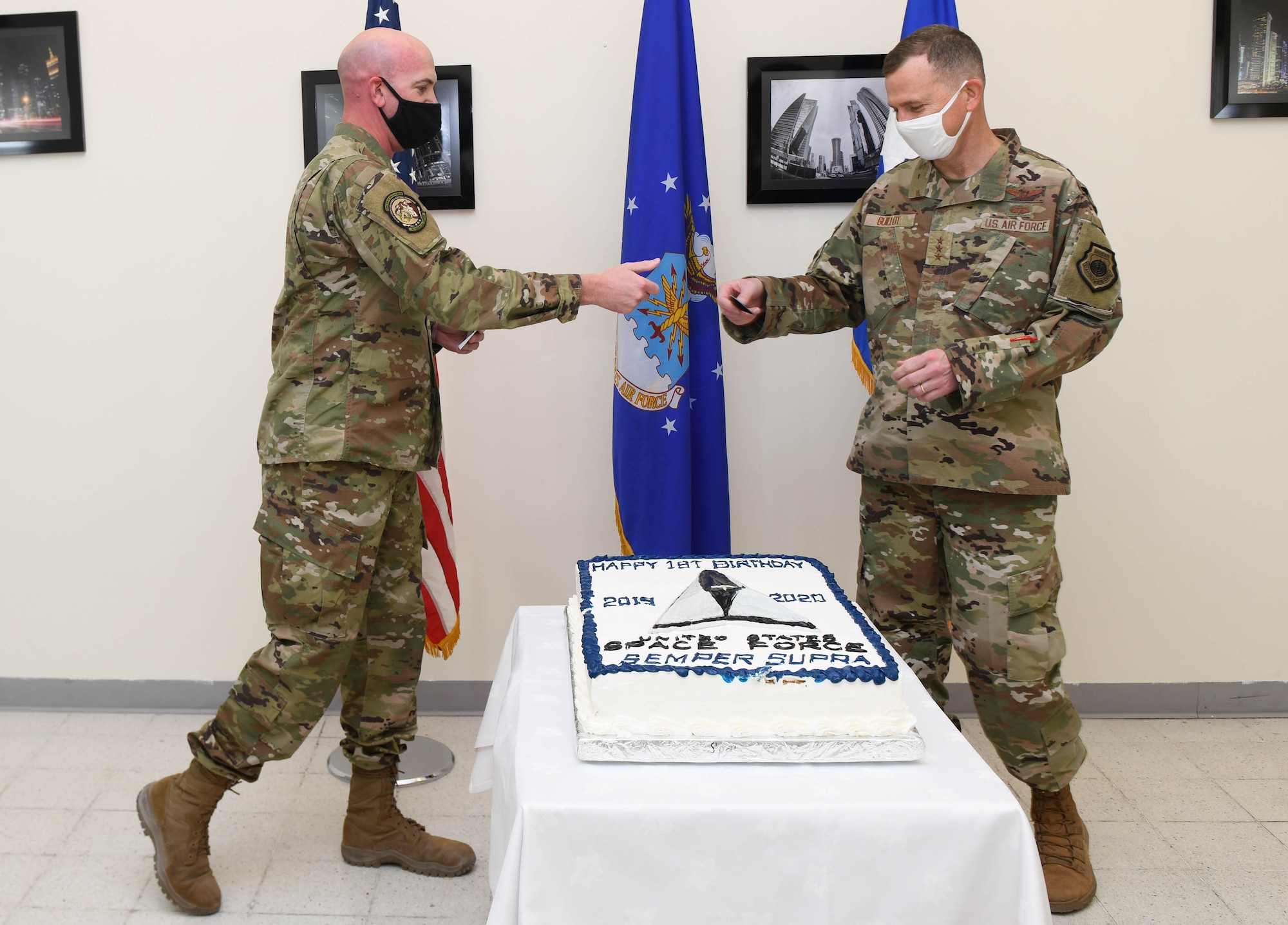 U.S. Space Force Col. Robert Schreiner, incoming director of Space Forces, U.S. Air Forces Central, gives U.S. Air Force Lt. Gen. Gregory Guillot, 9th Air Force (AFCENT) commander, a Space Force patch during the Space Force first birthday celebration on Dec. 20, 2020, at Al Udeid Air Base, Qatar. The Space Force became the newest branch of the U.S. military to be established in more than 70 years, with a dedicated space warfare and space operations mission. (U.S. Air Force photo by Staff Sgt. Kayla White)