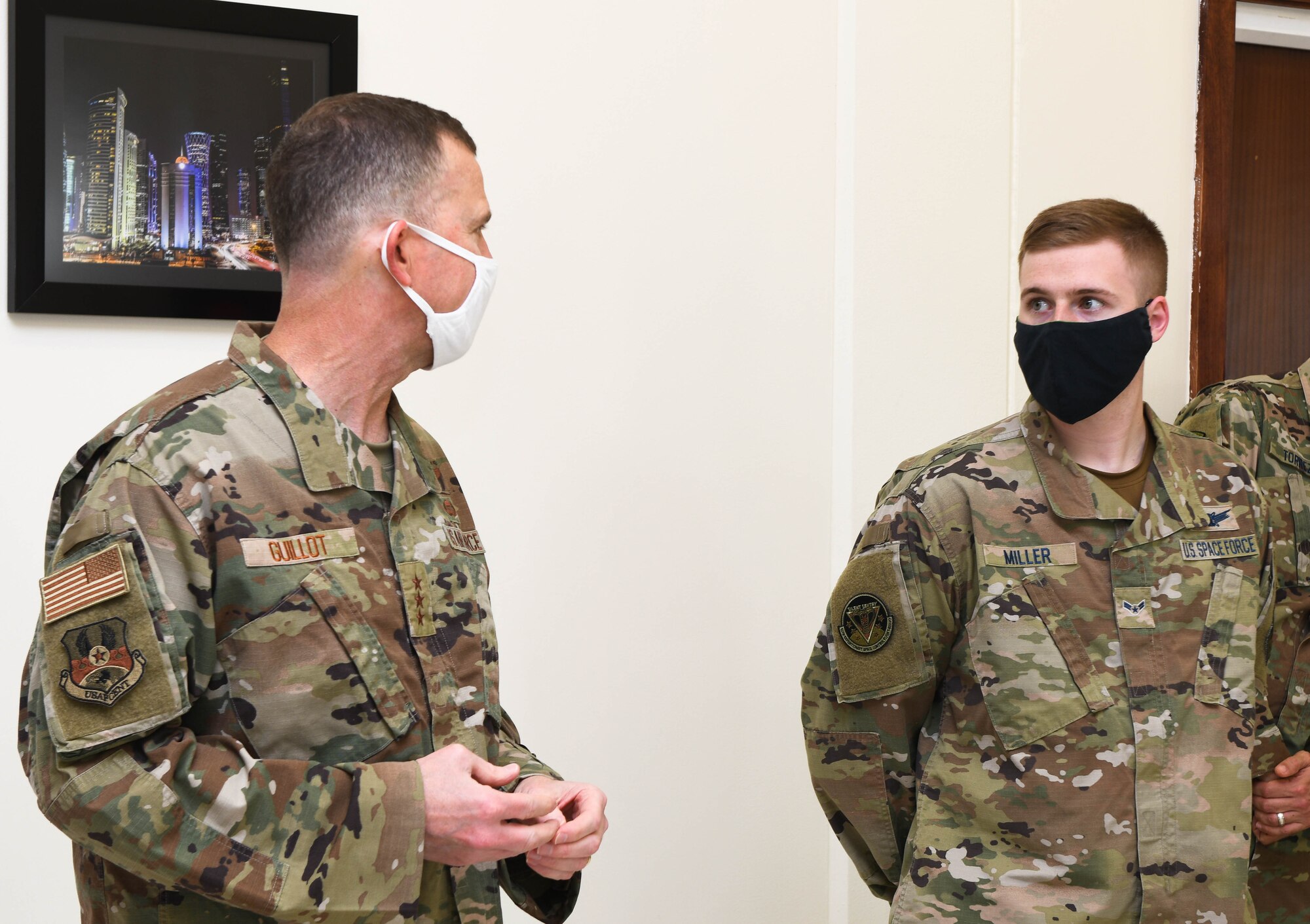 U.S. Air Force Lt. Gen. Gregory Guillot, 9th Air Force (Air Forces Central) commander, addresses U.S. Space Force Airman 1st Class Jason Miller, 16th Expeditionary Space Control Flight space console operator, during the Space Force first birthday celebration on Dec. 20, 2020, at Al Udeid Air Base, Qatar. Miller became one of the first, and youngest, deployed enlisted Space Force members who transitioned from the U.S. Air Force on Sept. 1, 2020. The Space Force became the newest branch of the U.S. military to be established in more than 70 years, with a dedicated space warfare and space operations mission. (U.S. Air Force photo by Staff Sgt. Kayla White)