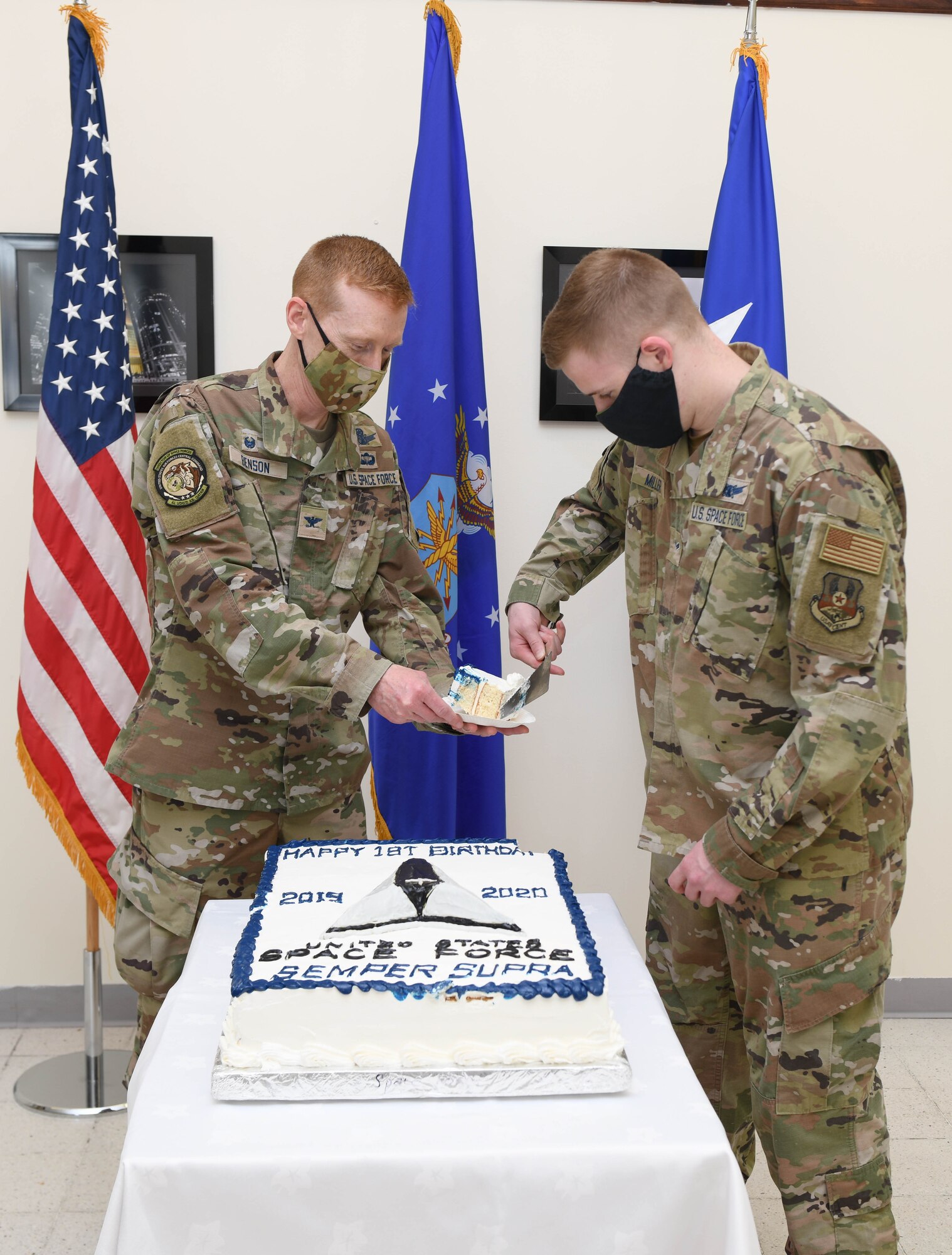 U.S. Space Force Col. Todd Benson, director of Space Forces, U.S. Air Forces Central, and U.S. Space Force Airman 1st Class Jason Miller, 16th Expeditionary Space Control Flight space console operator, cut a cake during the Space Force first birthday celebration on Dec. 20, 2020, at Al Udeid Air Base, Qatar. Benson is the oldest and Miller is the youngest deployed Space Force members at Al Udeid AB. The Space Force became the newest branch of the U.S. military to be established in more than 70 years, with a dedicated space warfare and space operations mission. (U.S. Air Force photo by Staff Sgt. Kayla White)