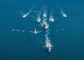 The Royal Saudi Naval Force corvette HMS Badr (612), front to back, the guided-missile destroyer USS Winston S. Churchill (DDG 81), Navy patrol coastal ships USS Squall (PC 7), USS Firebolt (PC 10), Coast Guard patrol boats USCGC Monomoy (WPB 1326), USCGC Maui (WPB 1304) and USCGC Wrangell (WPB 1332) transit the Arabian Gulf with Royal Saudi Air Force F-15SA fighter jets, U.S. Air Force F-16 Fighting Falcon fighter jets, a U.S. Navy MH-60R Sea Hawk helicopter and a U.S. Navy P-8A Poseidon aircraft during the joint and combined air operations in support of maritime surface warfare (AOMSW) exercise in the Arabian Gulf, Dec. 17. Combined integration operations between joint U.S. forces are regularly held to maintain interoperability and the capability to counter threats posed in the maritime domain, ensuring freedom of navigation and free flow of commerce throughout the region's heavily trafficked waterways. (U.S. Navy photo by Mass Communication Specialist 3rd Class Louis Thompson Staats IV)