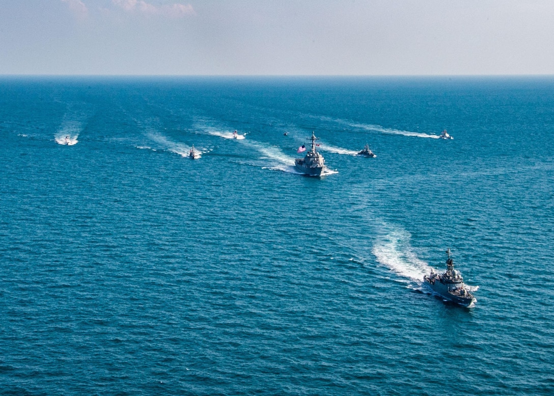 The Royal Saudi Naval Force corvette HMS Badr (612), front to back, the guided-missile destroyer USS Winston S. Churchill (DDG 81), center, Navy patrol coastal ships USS Squall (PC 7), USS Firebolt (PC 10), Coast Guard patrol boats USCGC Monomoy (WPB 1326), USCGC Maui (WPB 1304) and USCGC Wrangell (WPB 1332) transit the Arabian Gulf during the joint and combined air operations in support of maritime surface warfare (AOMSW) exercise in the Arabian Gulf, Dec. 17. Combined integration operations between joint U.S. forces are regularly held to maintain interoperability and the capability to counter threats posed in the maritime domain, ensuring freedom of navigation and free flow of commerce throughout the region's heavily trafficked waterways.