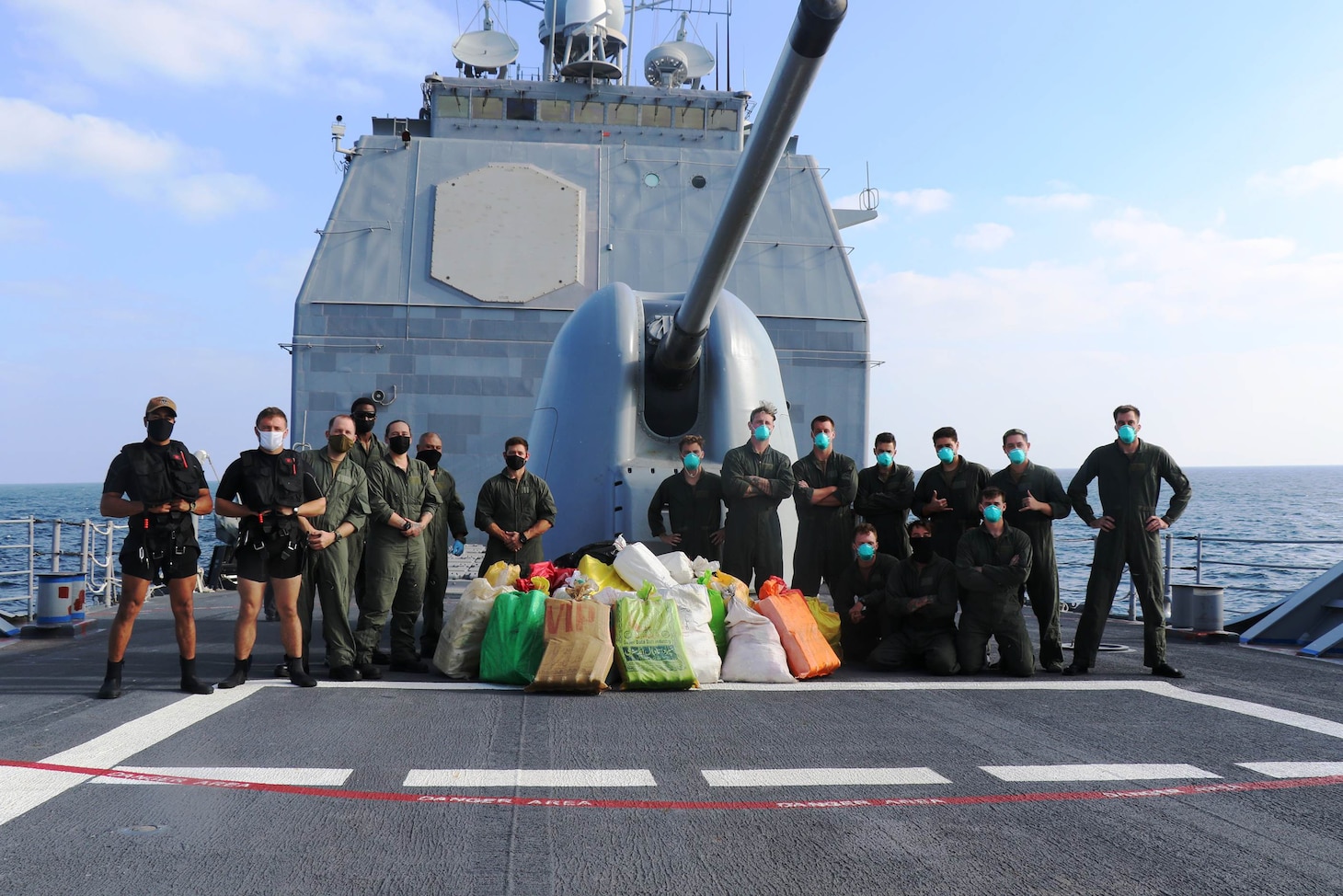 Sailors stationed about the guided-missile cruiser USS Port Royal (CG 73), deployed to U.S. Fifth Fleet and operating in support of the Combined Maritime Forces (CMF), monitor bags suspected narcotics seized from a stateless dhow in the international waters of the North Arabian Sea, Dec. 18. CMF is a multinational maritime partnership which exists to counter illicit non-state actors on the high seas, promoting security, stability and prosperity in the Arabian Gulf, the Red Sea, Gulf of Aden, Indian Ocean and Gulf of Oman. CTF 150 conducts maritime security operations outside the Arabian Gulf to disrupt criminal and terrorist organizations, ensuring legitimate commercial shipping can transit the region free from non-state threats.