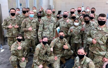 U.S. Army Medical Center of Excellence Command Sgt. Maj. Clark Charpentier (center) pictured with Army trainees and one Air Force trainee, assigned to Joint Base San Antonio-Fort Sam Houston Texas as they await travel on Holiday Block Leave at the San Antonio International Airport Dec. 19.