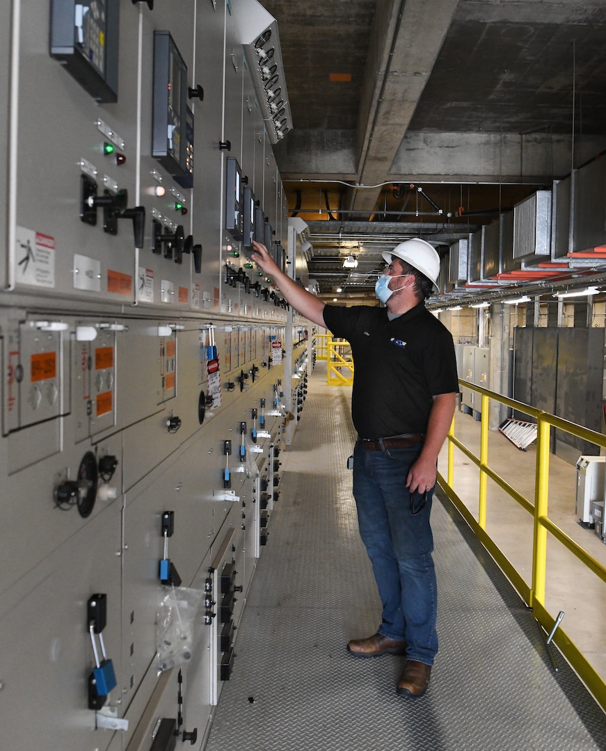 Tim Bagley, a system engineer for the electric utilities, checks the voltage and current on switchgear for the Aeopropulsion Systems Test Facility exhaust motors and unit subsystems, Sept. 10, 2020, at Arnold Air Force Base. The Arnold Engineering Development Complex Base Civil Engineering Branch, installed the new switchgear. (U.S. Air Force photo by Jill Pickett) (This image has been altered by obscuring a badge for security purposes.)