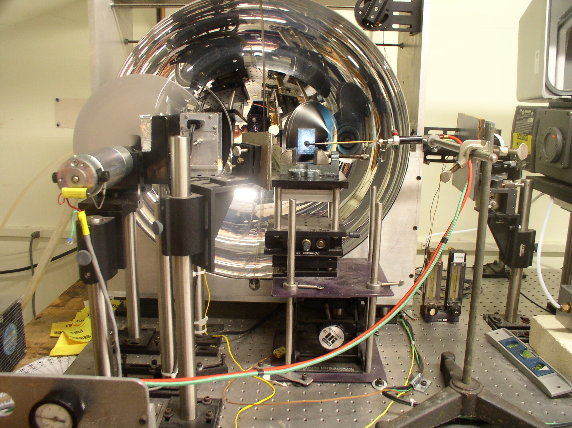 An acetylene torch is positioned to heat a sample in the legacy emissometer in the calibration laboratory of the Arnold Engineering Development Complex Aerothermal Measurements Laboratory at Arnold Air Force Base, Tenn. The sample was being heated before measuring it’s emissivity when bombarded by a blackbody simulator. The enhanced emissometer being developed for the ATML will include a built-in heat source and allow for measurements at additional angles. (U.S. Air Force photo)