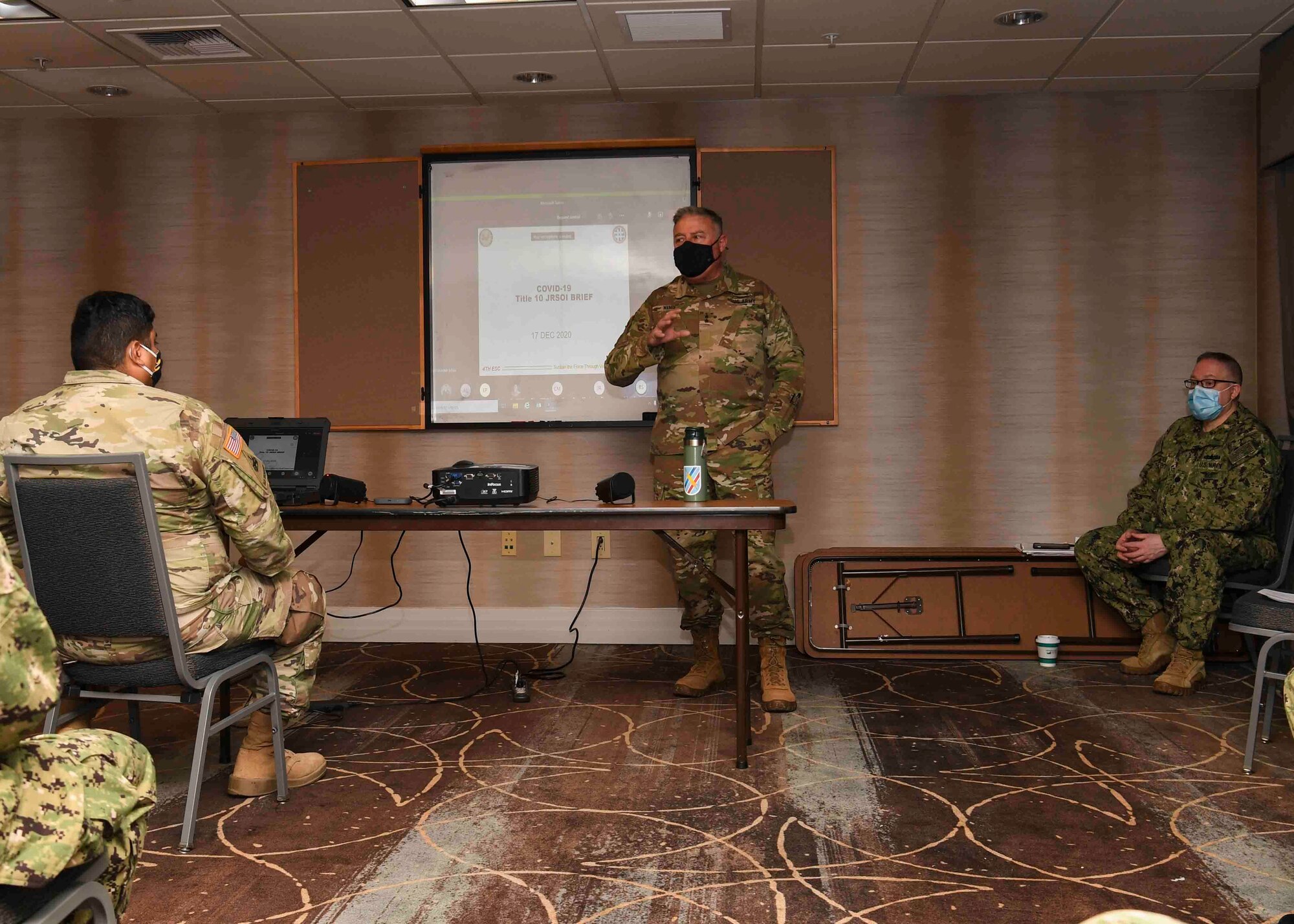 Service members receive a briefing.