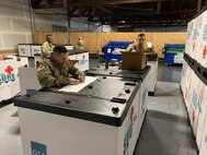 Soldiers from the 551st Medical Company (Logistics) and the 627th Hospital Center unload tri-walls of medical supplies as they arrive at Joint Base Lewis McChord, Washington, in support of COVID-19 relief efforts this past spring. (Courtesy)