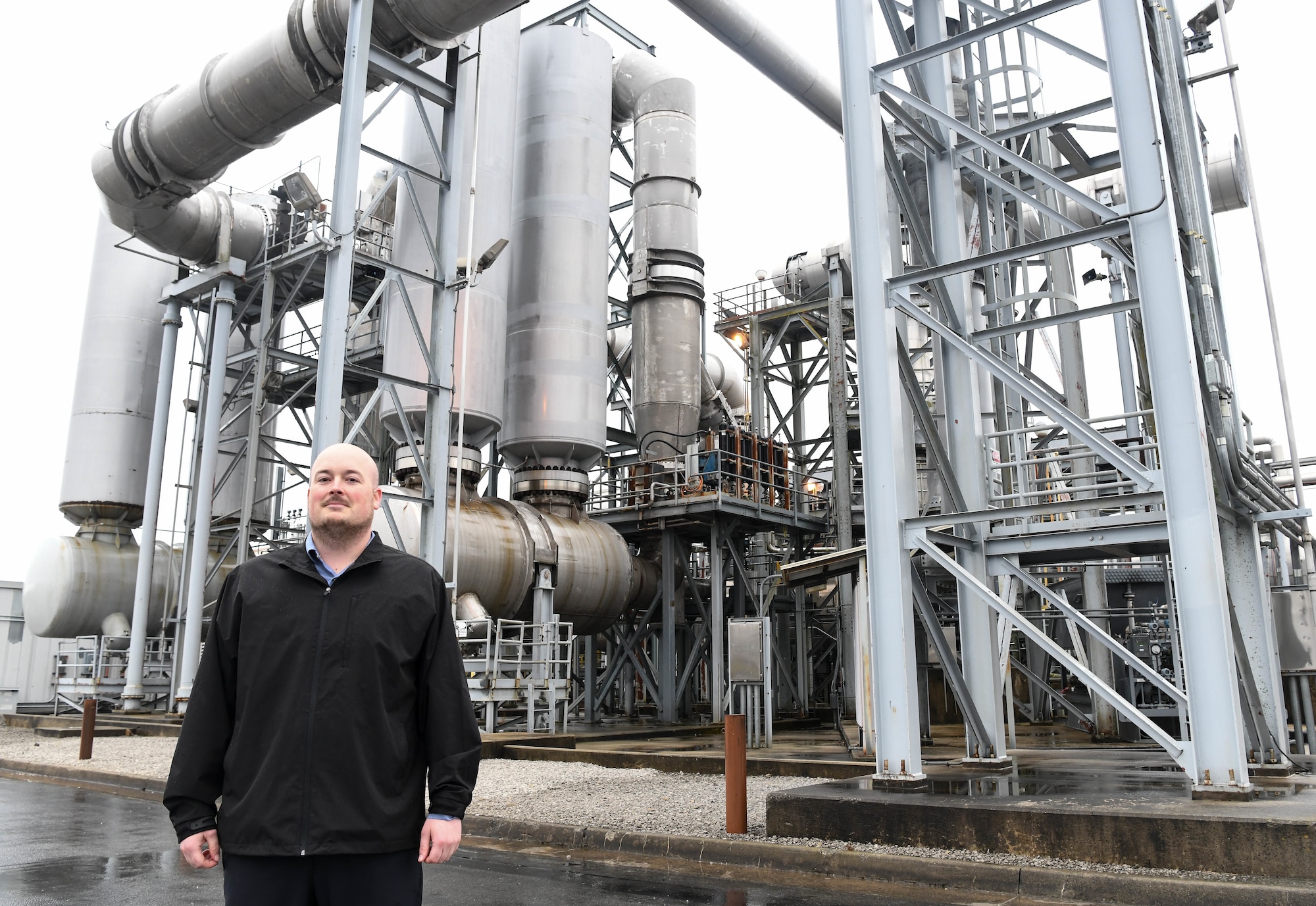 Bryon Harrington, a test engineer for the Propulsion Test Branch, Test Division, Arnold Engineering Development Complex, stands in front of an F100 engine outside of the Engine Test Facility at Arnold Air Force Base, Tenn., Dec. 4, 2020. When Harrington was an enlisted Airman in the U.S. Air Force he serviced and removed F100 engines. He now works as a civilian for an organization which has performed ground testing on the engine. (U.S. Air Force photo by Jill Pickett)