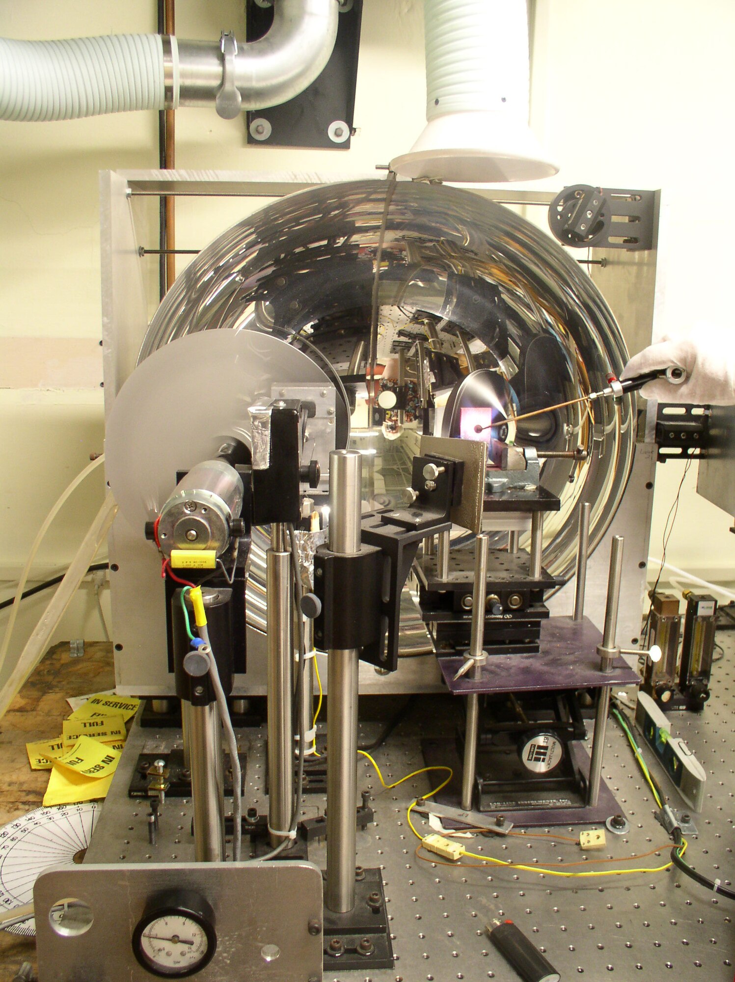 An acetylene torch is positioned to heat a sample in the legacy emissometer in the calibration laboratory of the Arnold Engineering Development Complex Aerothermal Measurements Laboratory at Arnold Air Force Base, Tenn. The sample was being heated before measuring it’s emissivity when bombarded by a blackbody simulator. The enhanced emissometer being developed for the ATML will include a built-in heat source and allow for measurements at additional angles. (U.S. Air Force photo)