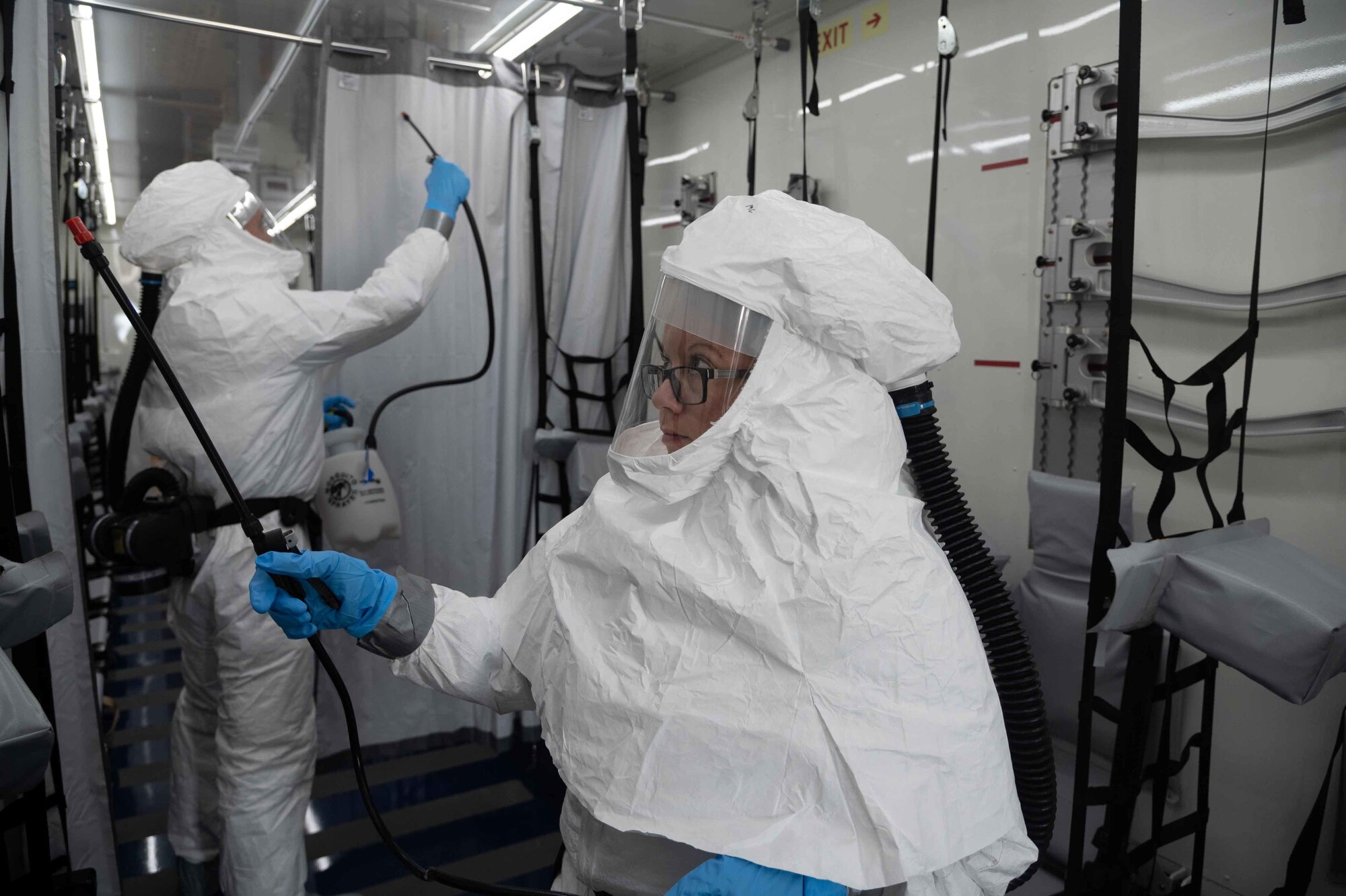 Tech. Sgt. Holly McCullough-Cruz, 775th Expeditionary Aeromedical Evacuation Flight biological containment unit noncommissioned officer in charge, decontaminates a negatively pressurized conex, Oct. 21, 2020 at Dover Air Force Base, Delaware. Dover AFB hosts two NPCs in support of COVID-19 medical evacuation operations and has transported 26 patients as of Dec. 15, 2020. (U.S. Air Force photo by Airman 1st Class Faith Schaefer)