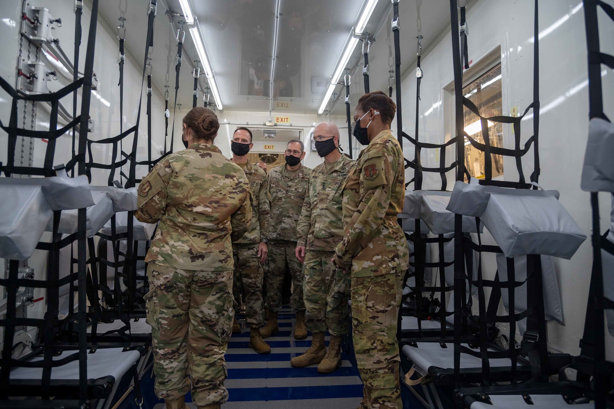 Capt. Alexis Todaro, Negatively Pressurized Conex program manager, gives a tour of an NPC to Lt. Gen. Ronald Place, Defense Health Agency director, and Brig. Gen. Norman West, Air Mobility Command surgeon general, during a base visit Oct. 21, 2020, at Dover Air Force Base, Delaware. Place and Sgt. Maj. Michael Gragg, Defense Health Agency senior enlisted leader, visited Dover Air Force Base to experience firsthand the missions of the 436th Medical Group, Armed Forces Medical Examiner System and Air Force Mortuary Affairs Operations. The DHA supports the delivery of integrated, affordable and high-quality health services to Military Health System beneficiaries and is responsible for driving greater integration of clinical and business processes across the MHS. (U.S. Air Force photo by Airman 1st Class Faith Schaefer)