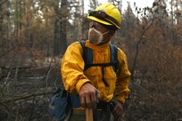 As the year would prove to be a record-breaking one for massive wildfires raging throughout the West, National Guard members were activated to help augment firefighters. Here, Chief Master Sgt. Daniel Garvida, an engineer superintendent with the Washington Air National Guard’s 194th Wing, sizes up the next challenge of a wildfire fight near Inchelium, Washington, Sept 16. Garvida as well as 14 other Air National Guard members from the 194th Wing and 225th Air Defense Group spent 10 days fighting fires in Eastern Washington.