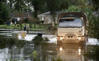 A Florida Army National Guard high water response vehicle makes its way through the flooded roads of Escambia County, Florida, as part of Hurricane Sally recovery efforts Sept. 16.