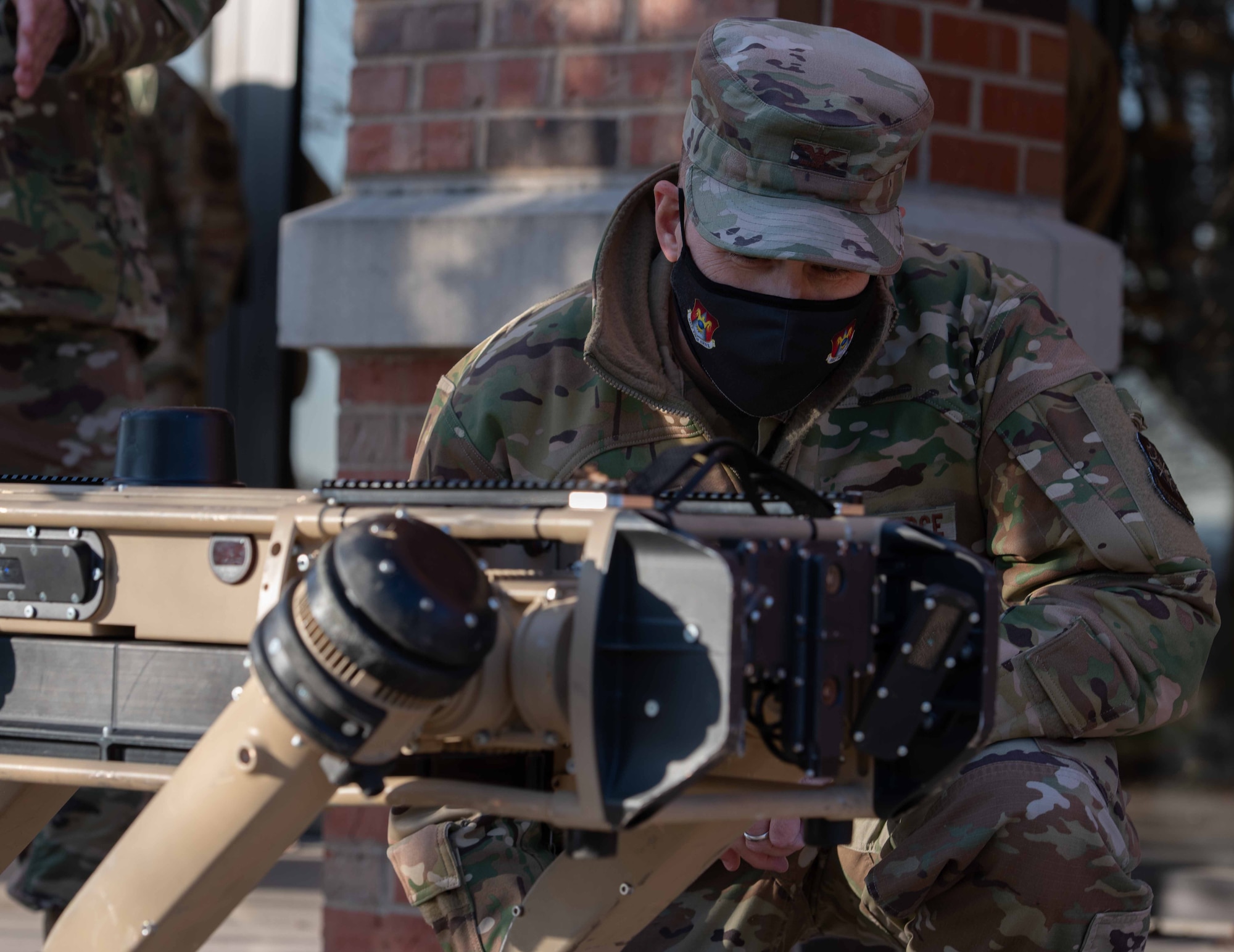 375th AMW commander looks at robot dog