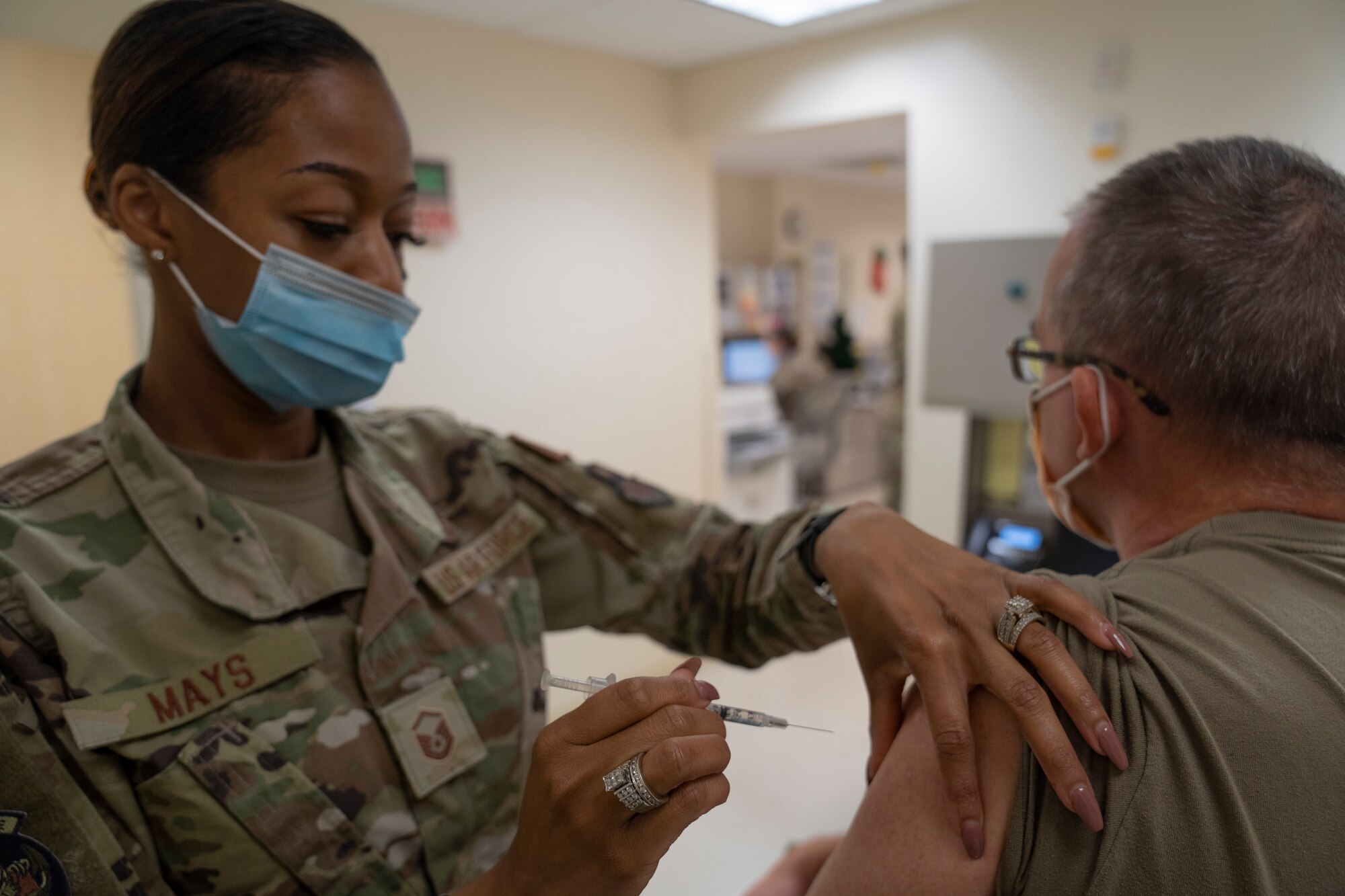 U.S. Air Force Master Sgt. La'Kisha Mays, 81st Healthcare Operations Squadron medical specialties flight chief, administers the COVID-19 vaccine to Col. Wayne Latack, 81st Medical Group internal medicine residency program director, inside the Keesler Medical Center at Keesler Air Force Base, Mississippi, Dec. 21, 2020. Members of the 81st MDG administered the COVID-19 vaccine to Keesler first responders and members of the Armed Forces Retirement Home in Gulfport, Mississippi. (U.S. Air Force photo by Airman 1st Class Kimberly L. Mueller)