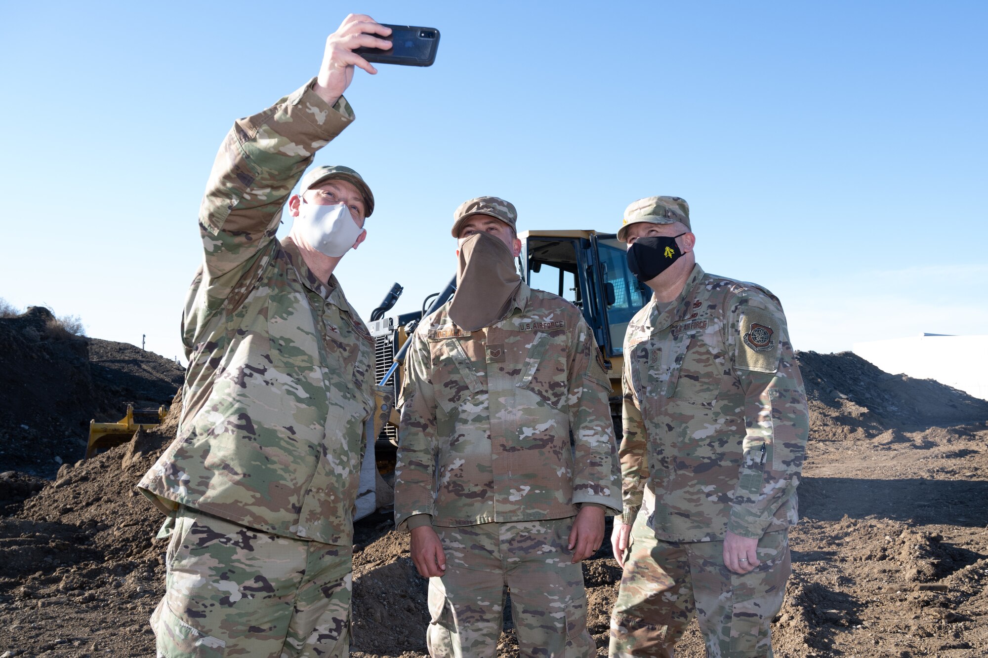Airman taking pictures with the commander and command chief.