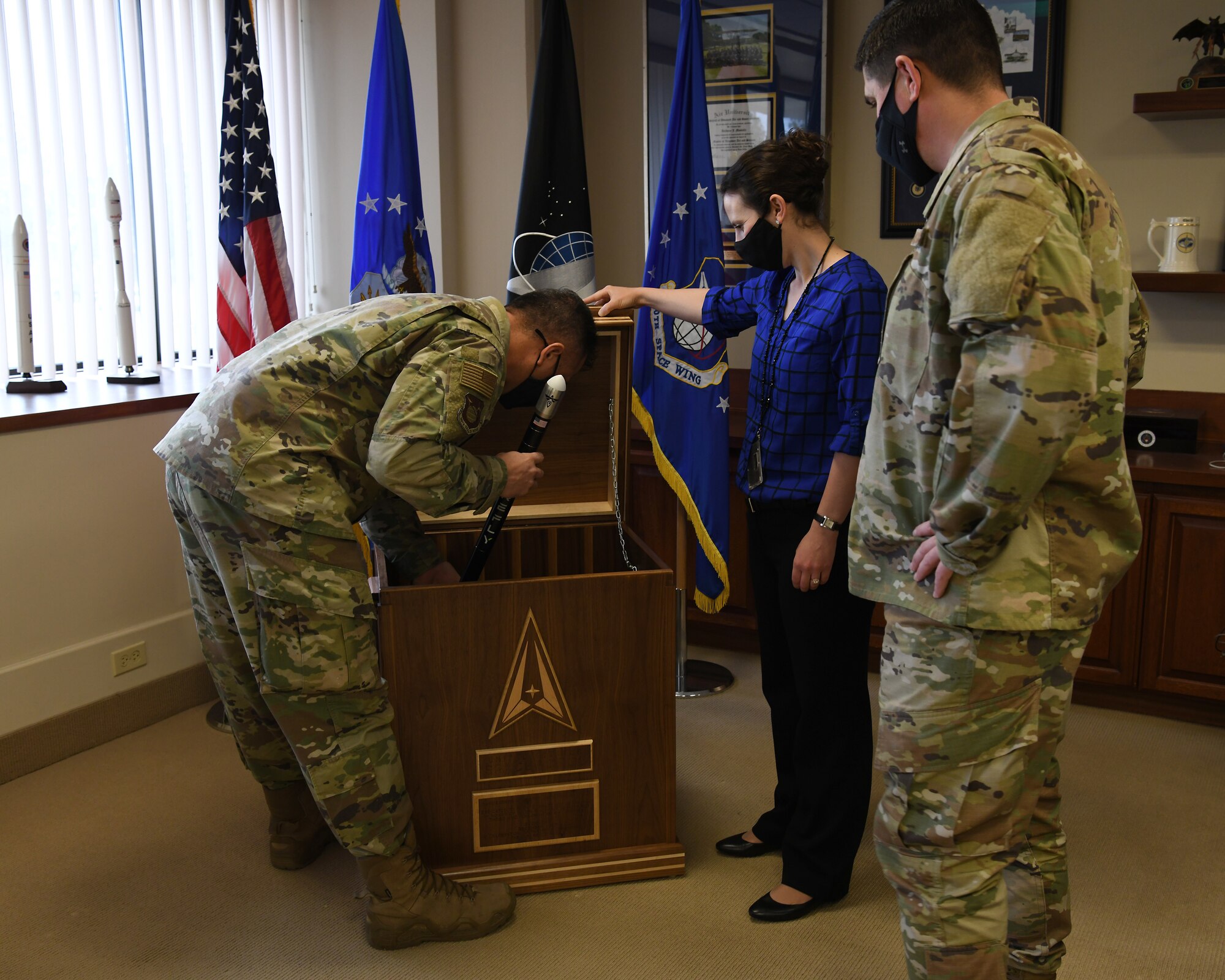 Col. Anthony Mastalir, 30th Space Wing commander, places the final item into the 30th Space Wing 2020 time capsule Dec. 17, 2020, at Vandenberg Air Force Base, Calif.